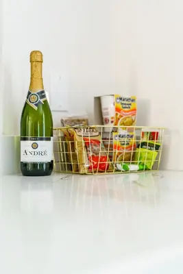 a bottle of wine and a basket of food at Jungle House Luxury Stays - Columbus Downtown Short North in Columbus
