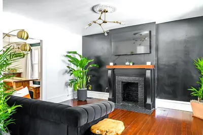 a living room with a couch and a fireplace at Jungle House Luxury Stays - Columbus Downtown Short North in Columbus