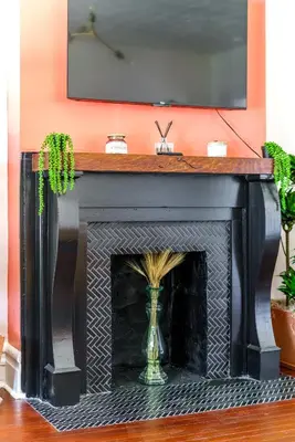 a black fireplace with a vase on top of it at Jungle House Luxury Homes - Columbus Downtown Short North - Walk to Convention Center & Nationwide Arena - Sleeps up to 8 - Free Parking - Over 5,800 Five Stars in Columbus