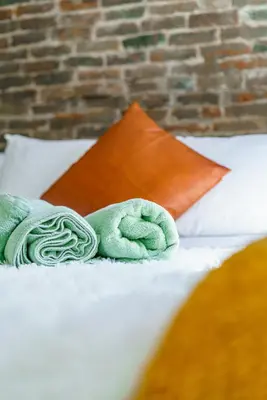 a pair of towels sitting on top of a bed at Jungle House Luxury Homes - Columbus Downtown Short North - Walk to Convention Center & Nationwide Arena - Sleeps up to 8 - Free Parking - Over 5,800 Five Stars in Columbus