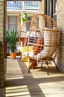 two wicker chairs and a table on a porch at Jungle House Luxury Homes - Columbus Downtown Short North - Walk to Convention Center & Nationwide Arena - Sleeps up to 8 - Free Parking - Over 5,800 Five Stars in Columbus