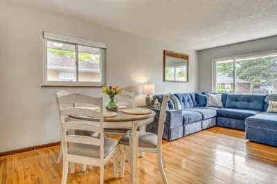 a living room with a blue couch and a table at 7 Mi to Downtown Columbus Family Getaway with Yard in Columbus