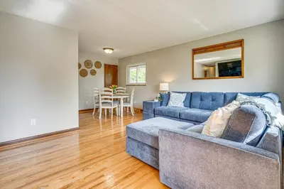 a living room with a blue couch and a table at 7 Mi to Downtown Columbus Family Getaway with Yard in Columbus