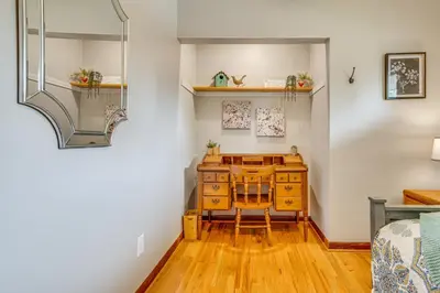 a room with a desk and a bed and a mirror at 7 Mi to Downtown Columbus Family Getaway with Yard in Columbus