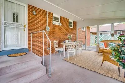 a patio with a table and chairs next to a brick building at 7 Mi to Downtown Columbus Family Getaway with Yard in Columbus