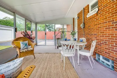 a patio with a table and chairs and a brick wall at 7 Mi to Downtown Columbus Family Getaway with Yard in Columbus