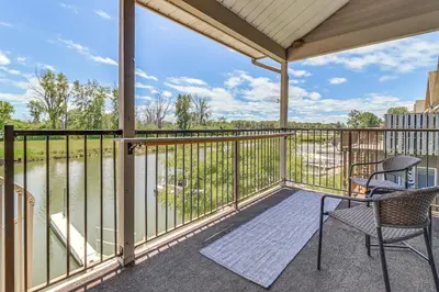 a patio with two chairs and a table on a balcony at 13 Mi to Port Clinton Lake Erie Getaway with Dock in Oak Harbor