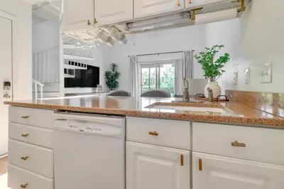 a kitchen with white cabinets and a granite counter top at 13 Mi to Port Clinton Lake Erie Getaway with Dock in Oak Harbor
