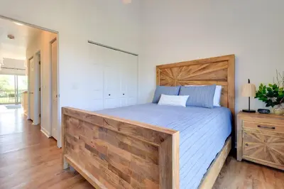 a bedroom with a large bed with a wooden headboard at 13 Mi to Port Clinton Lake Erie Getaway with Dock in Oak Harbor