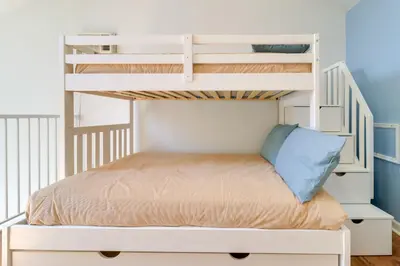 a bunk bed in a white bunk bed room at 13 Mi to Port Clinton Lake Erie Getaway with Dock in Oak Harbor