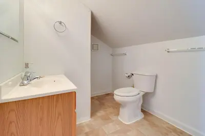 a bathroom with a white toilet and a sink at 13 Mi to Port Clinton Lake Erie Getaway with Dock in Oak Harbor