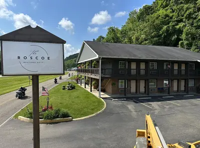 a building with a sign in front of it at The Roscoe Boutique Motel in Coshocton