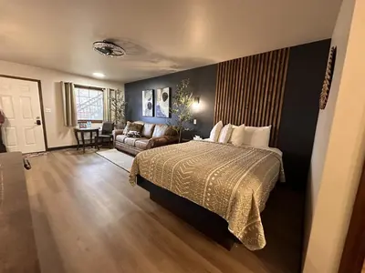 a hotel room with a bed and a couch at The Roscoe Boutique Motel in Coshocton