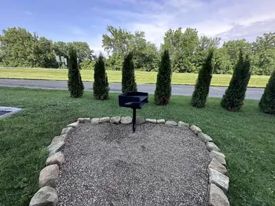 a black object sitting in the middle of a yard at The Roscoe Boutique Motel in Coshocton