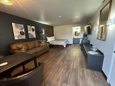 a living room with a couch and a table at The Roscoe Boutique Motel in Coshocton