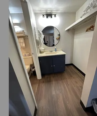 a bathroom with a sink and a mirror at The Roscoe Boutique Motel in Coshocton