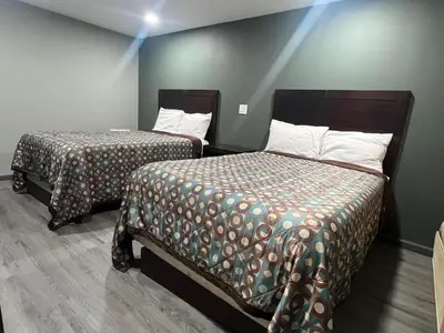 a room with two beds in a room at Red Carpet Inn in Garfield Heights