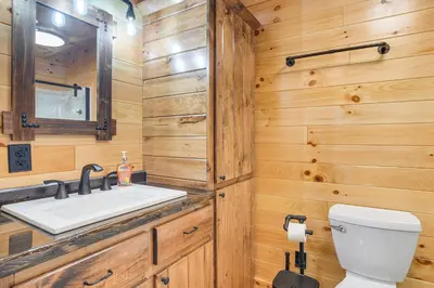 a bathroom with a sink and a toilet at Chillicothe Cabin Near Hocking Hills State Park! in Chillicothe