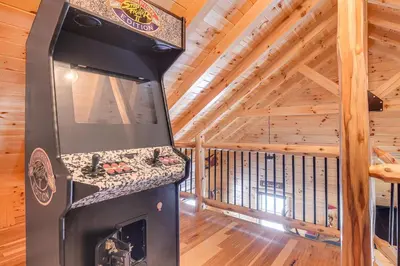 a kitchen with a fireplace in a log cabin at Chillicothe Cabin Near Hocking Hills State Park! in Chillicothe