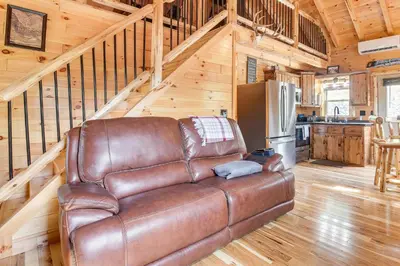a leather couch sitting in a living room in a cabin at Chillicothe Cabin Near Hocking Hills State Park! in Chillicothe