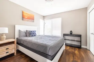 a white bedroom with a bed and a window at Luxury Downtown Townhome Private Garage Unit 16 in Cleveland