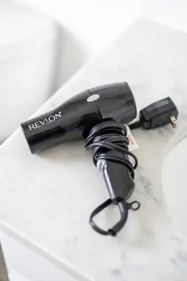 a black hair dryer sitting on top of a table at Luxury Downtown Townhome Private Garage Unit 16 in Cleveland