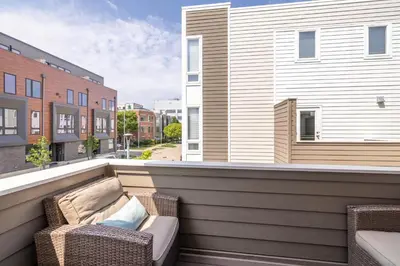 a balcony with a couch and chairs on a building at Luxury Downtown Townhome Private Garage Unit 16 in Cleveland
