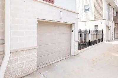 a garage door in a white brick building at Luxury Downtown Townhome Private Garage Unit 9 in Cleveland