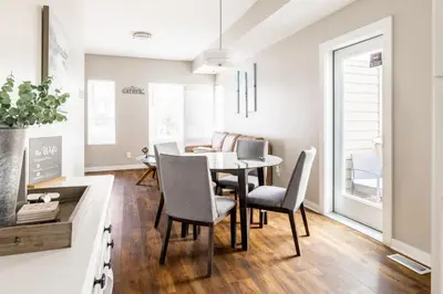 a kitchen and dining room with a table and chairs at Luxury Downtown Townhome Private Garage Unit 9 in Cleveland