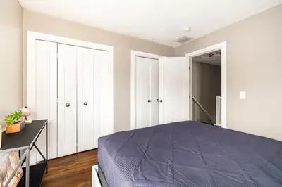 a bedroom with a bed and white cabinets at Luxury Downtown Townhome Private Garage Unit 9 in Cleveland