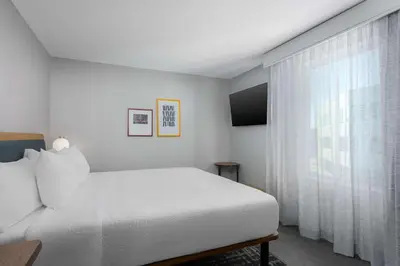 a bedroom with a white bed and a window at Homewood Suites By Hilton Newport Cincinnati in Newport