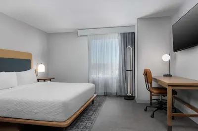 a bedroom with a bed and a desk and a computer at Homewood Suites By Hilton Newport Cincinnati in Newport