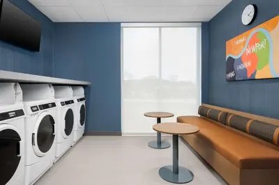 a laundry room with a washer and dryer at Homewood Suites By Hilton Newport Cincinnati in Newport