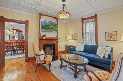 a living room with a blue couch and a table at Charming Victorian Home - 2 minutes to downtown in Lancaster