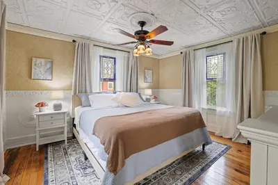 a bedroom with a bed and a ceiling fan at Charming Victorian Home - 2 minutes to downtown in Lancaster