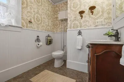 a bathroom with a toilet and a sink at Charming Victorian Home - 2 minutes to downtown in Lancaster