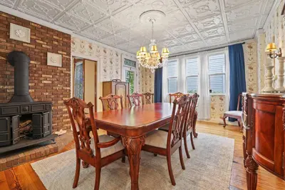 a dining room with a table and a fireplace at Charming Victorian Home - 2 minutes to downtown in Lancaster
