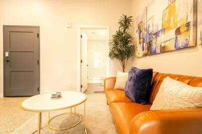 a living room with a couch and a table at Bengals Paycor Reds 6 min Walk Free Parking in Cincinnati