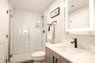 a white bathroom with a toilet and a sink at Bengals Paycor Reds 6 min Walk Free Parking in Cincinnati