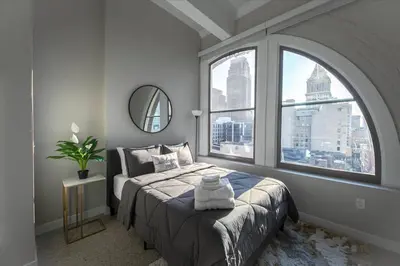 a bedroom with a bed and a large window at Bengals Paycor Reds 6 min Walk Free Parking in Cincinnati