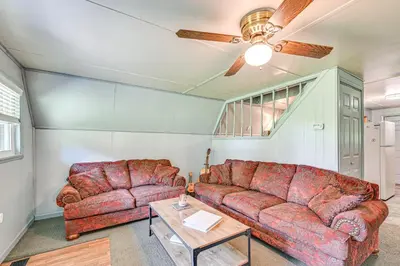 a living room with two couches and a table at 5 Mi to Cave Run Lake Wellington Cabin with Deck! in Wellington
