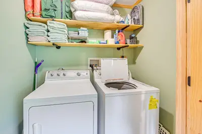 a laundry room with a washing machine and towels at 5 Mi to Cave Run Lake Wellington Cabin with Deck! in Wellington