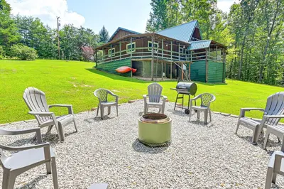 a group of chairs and a grill in front of a house at 5 Mi to Cave Run Lake Wellington Cabin with Deck! in Wellington