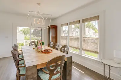 a dining room with a table and chairs and windows at Port Clinton Home with Lake View - Walk to Beach! in Port Clinton