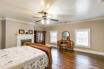 a bedroom with a bed and a ceiling fan at Vineyard Retreat at George Vest Historical Home in Verona