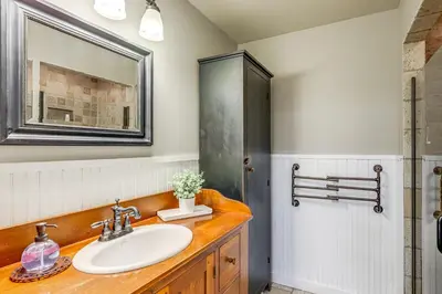 a bathroom with a sink and a mirror at Vineyard Retreat at George Vest Historical Home in Verona