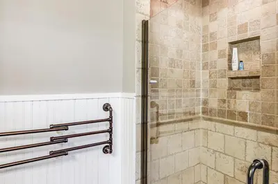 a bathroom with a shower with a glass door at Vineyard Retreat at George Vest Historical Home in Verona