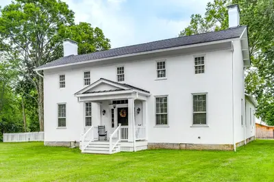 an old white house with a lawn at Vineyard Retreat at George Vest Historical Home in Verona