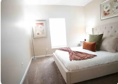 a bedroom with a bed with white walls and a window at Cozy King 2 bedroom at Easton near Airport in Columbus