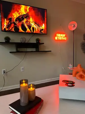 a living room with a fireplace with candles and a tv at Cozy King 2 bedroom at Easton near Airport in Columbus